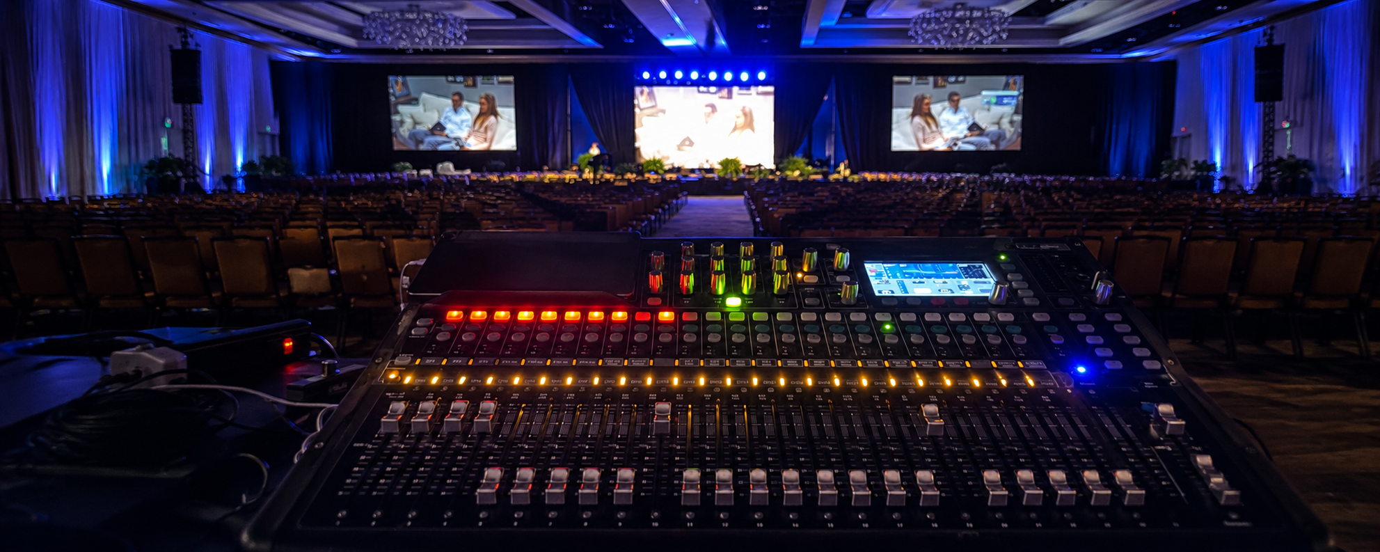 Live event audio visual production in Orlando with digital mixing console, stage screens and conference presentation control setup